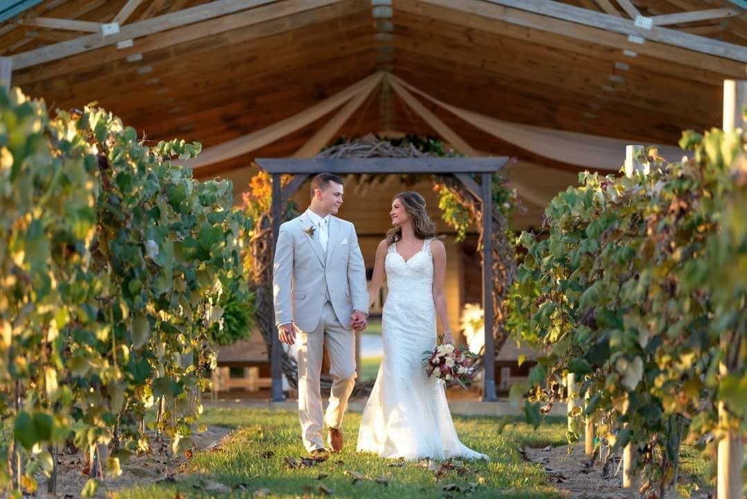 Outdoor wedding ceremony with floral arch at Logan Vineyards